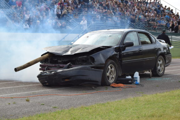 black wrecked car used in a mock DUI accident
