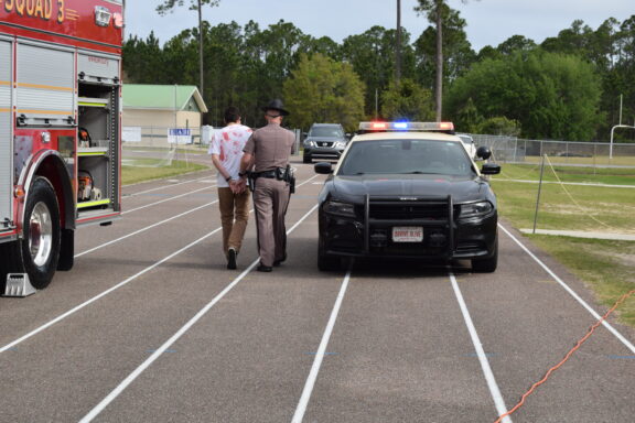 FL state trooper performs an arrest at a mock DUI accident