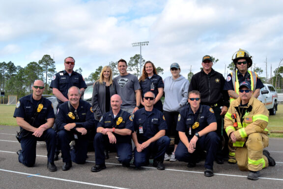 WCFR team and local first responders lined up kneeling