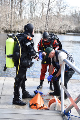 The Walton County Sheriff's Office Dive Team takes off their gear after locating the body of a missing person at Morrison Springs. 