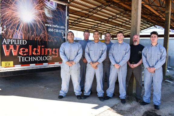 Six inmates, including two from Escambia County pose with Instructor Scott Bennett after graduating from the Applied Welding Technology Class at the Walton County Jail. 