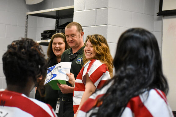 A felame inmate smiles when receiving her ServSafe certificate during her incarceration at the Walton County Jail. 