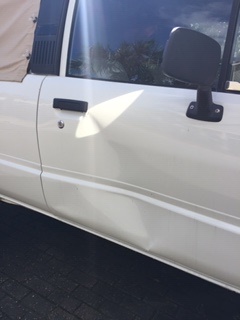White Truck Door with Dent Under Door Handle