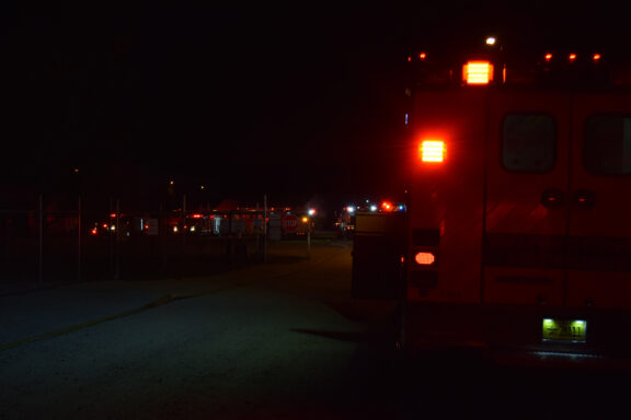 Ambulances and Fire Trucks with Lights on in the Dark
