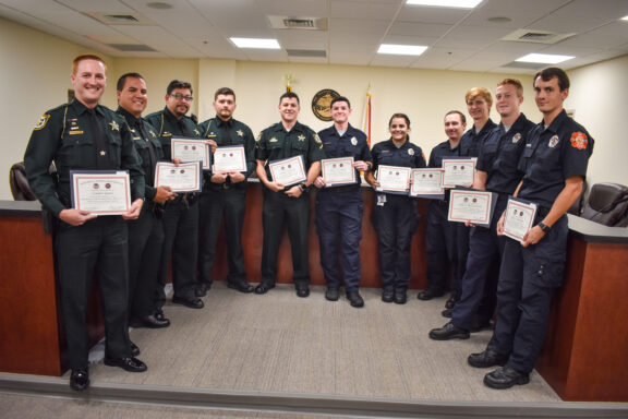 Eight firefighters and eight deputies from Walton County Sheriff’s Office pose with their newly achieved EMT Certifications