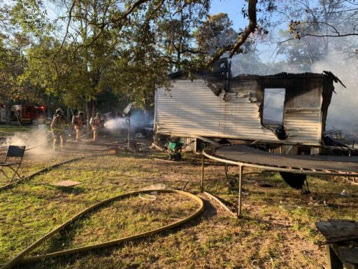 Burned Mobile Home Next to Trampoline