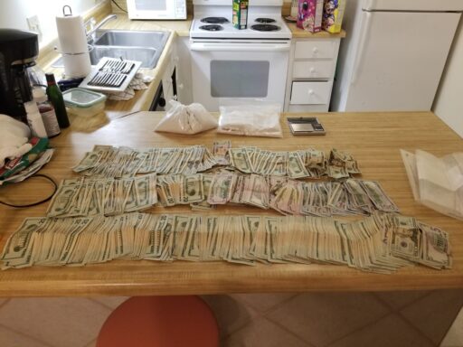 CASH AND DRUGS LAID OUT ON A TABLE