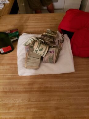 A PILE OF CASH CONFISCATED DURING WARRANT EXECUTION