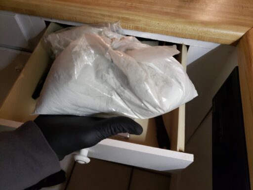 DRUGS BEHIND HELD OVER A DRAWER IT WAS FOUND IN