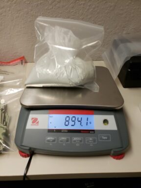 DRUGS BEING WEIGHED ON A SCALE