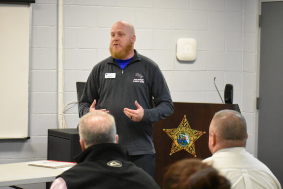 Bill Allison, the Director of Professional and Workforce Training at Northwest Florida State College addresses inmates.