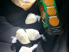 Four baggies of cocaine sitting on the passenger seat of a car.