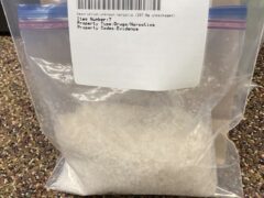 Bag of white unknown substance in an evidence bag.