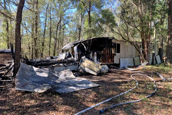 Hole in the side of mobile home after structure fire