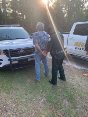 Deputy putting handcuffs on suspect