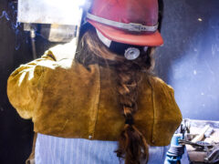 A woman with braided brunette. hair welds at the Walton County Jail.