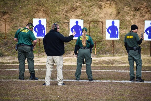 Instructor demonstrating how to shoot on a shooting range