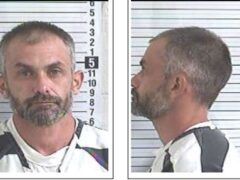 Side-by-side mug shots of a white male with salt and pepper hair and facial hair. He is wearing a black and white stripped inmate uniform.