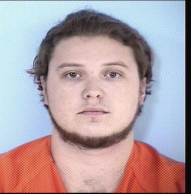 Mug shot of a white male with brown hair and neck facial hair.