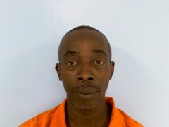 Mug shot of a black male in an orange jumpsuit