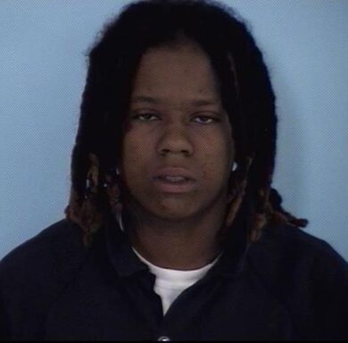 Mug shot of a black female with long dreads