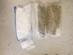 Two large plastic bags, one filled with white powdery substance the other contains marijuana.
