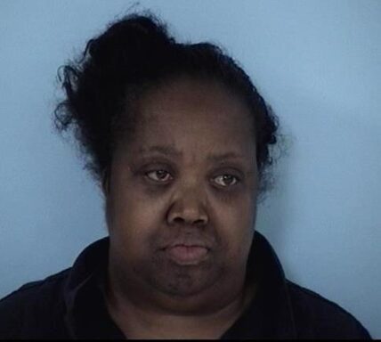 Mug shot of an African-American woman with her hair in a bun