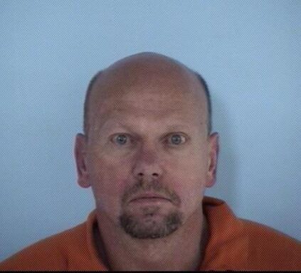 Mug shot of white male with brown goatee and balding head