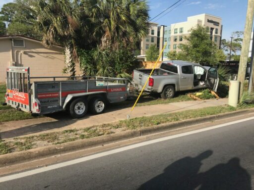 crashed truck with u-haul trailer