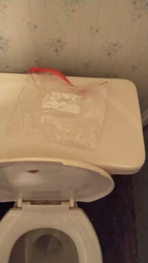 meth in a ziploc bag on top of a white toilet