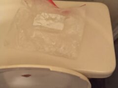 meth in a ziploc bag on top of a white toilet