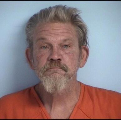 Mug shot of a white male with a gray and white qoatee and facial hair