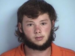 Mug shot of a white male with brown hair and a brown beard
