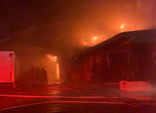 flames coming from a building at night