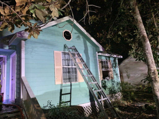 Light blue home with a ladder leaning on the side