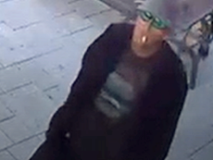 video surveillance snapshot of a mask with sunglasses and a hat on