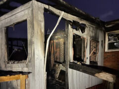White back porch of home damaged by fire