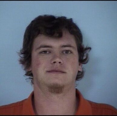 young white male with brown hair and brown goatee in orange jumpsuit