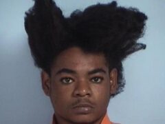 mug shot of a black male with afro