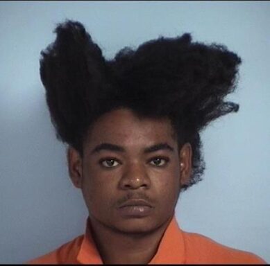 mug shot of a black male with afro