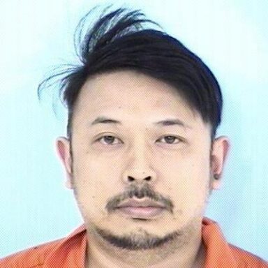 mug shot of an asian male with facial hair