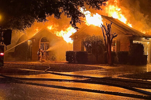 Large, single-story brick home on fire