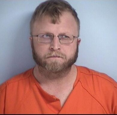 white male with light brown hair and beard wearing glasses