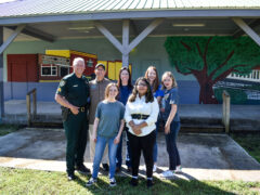Sergeant Wendel Poses with Bruce Naylor of Naylor Realty, artists Finch and Flores, Ms. Dotson, and two representatives from CCB Community Bank