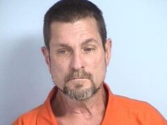 mug shot of a white male with brown and gray goatee