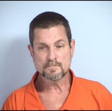 mug shot of a white male with brown and gray goatee