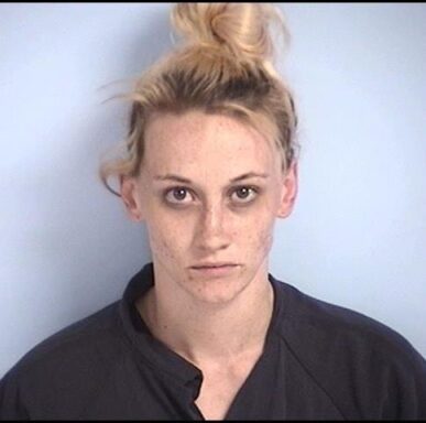 mug shot of a white female with blonde hair with dark roots