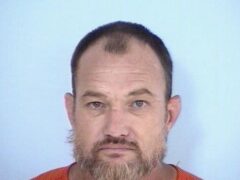 mug shot of a white male with gray and brown goatee
