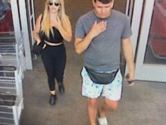 Blonde female and male with brown hair walk out of a store as seen on surveillance video