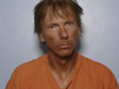 Mug shot of William Parker, white male with long brown shaggy hair
